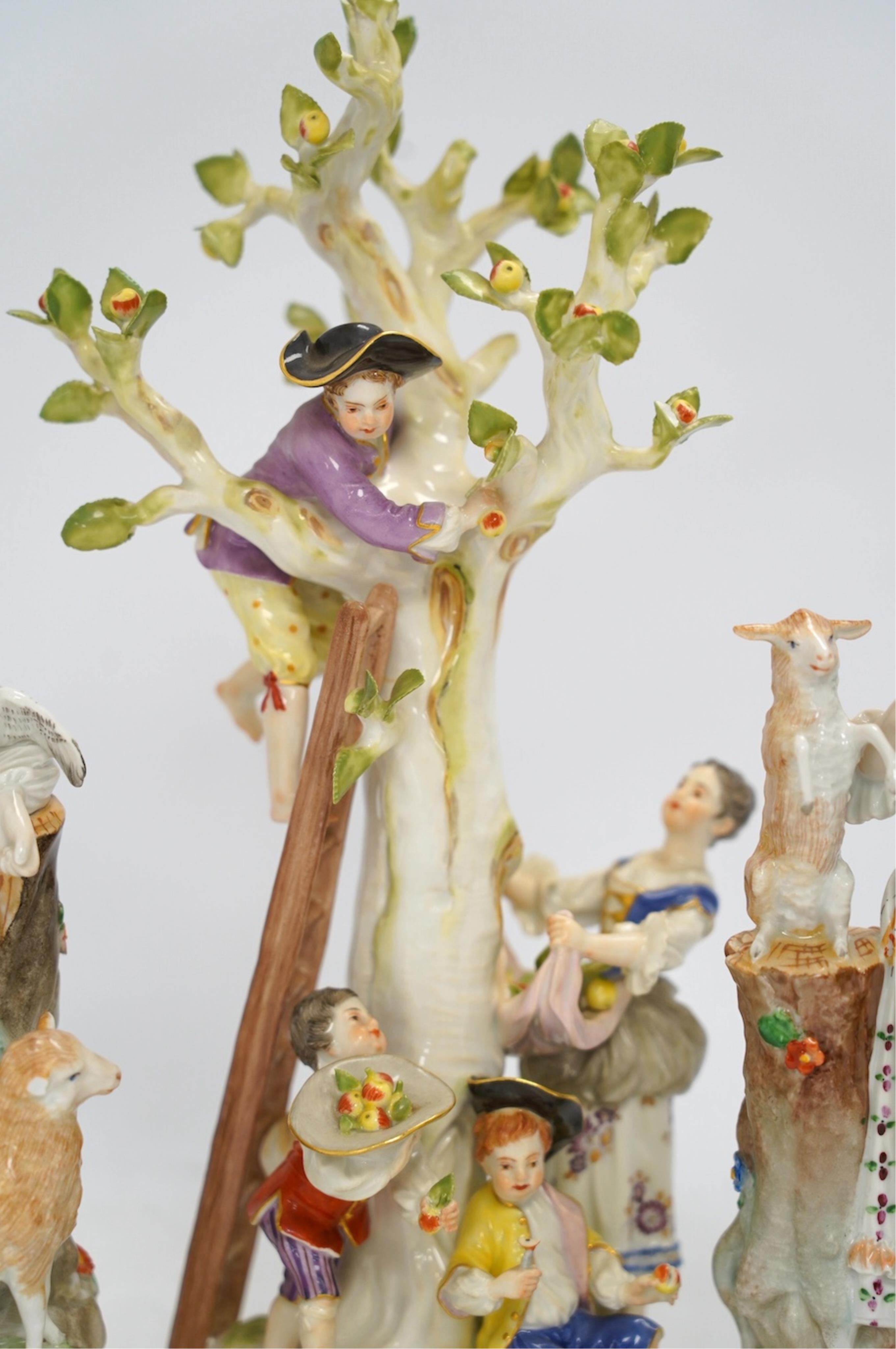 A Meissen apple pickers figure group and a pair of Dresden porcelain groups, tallest 29cm. Condition - some damage